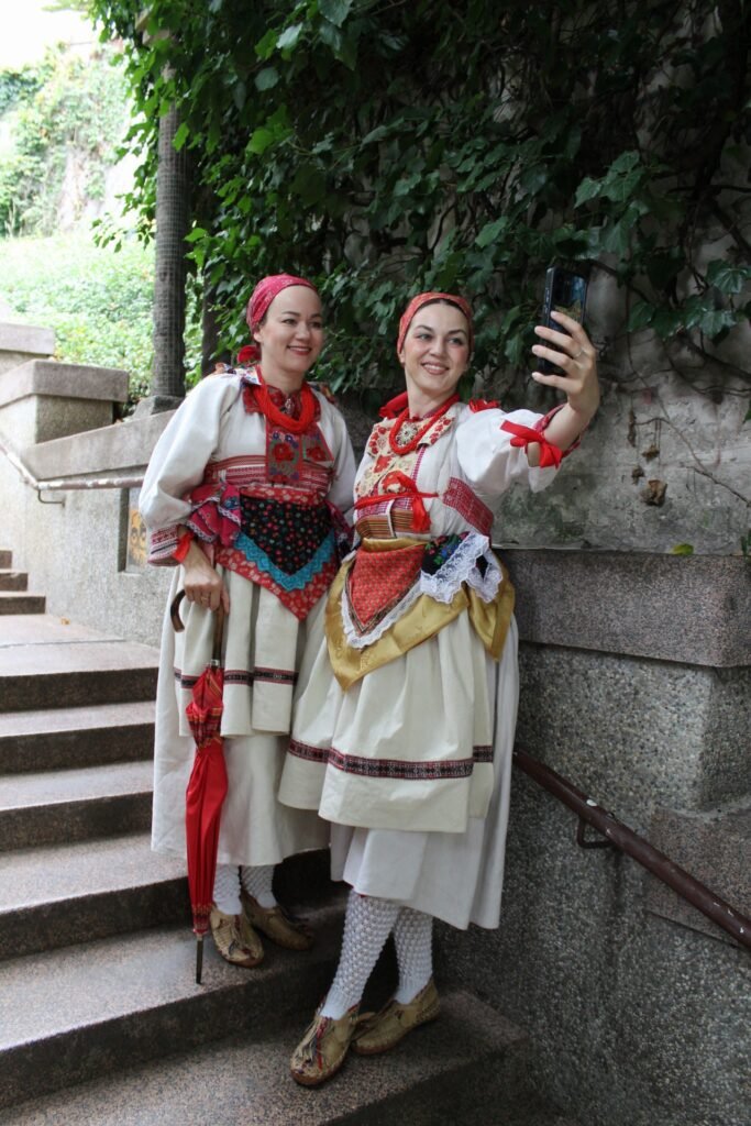2 ladies in Prigorje folk attire taking selfie on the Stross stairs